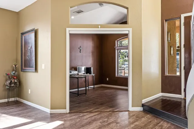 a view of a workspace with wooden floor and a bathroom