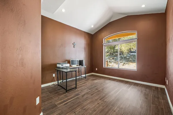 a view of a livingroom with wooden floor and a window