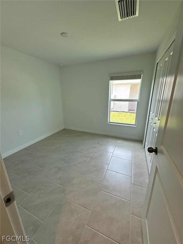 12312 Amber Waves Road Lehigh Acres, FL 33974 - Photo 24 of 33 a view of an empty room with a window