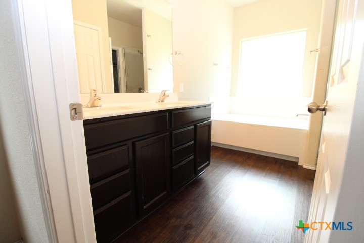 1202 Stonewall Ridge Harker Heights, TX 76548 - Photo 8 of 14 a bathroom with a sink and a mirror