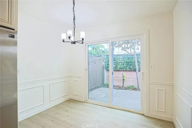 a kitchen with refrigerator a sink and white cabinets