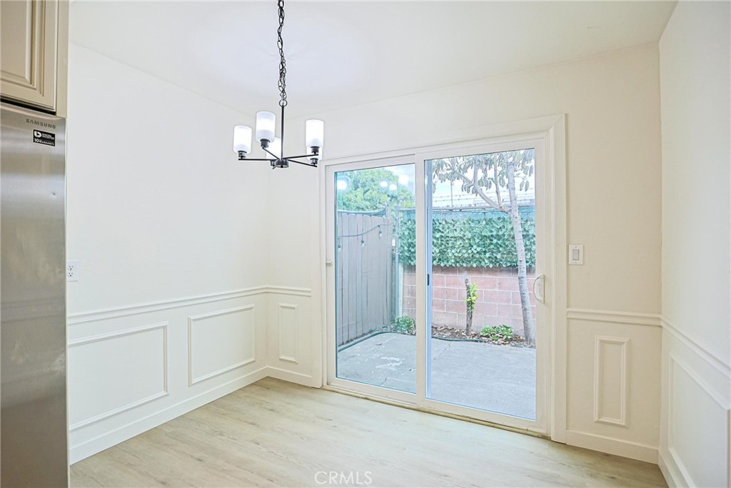 4109 West 5th Street, Unit F2 Santa Ana, CA 92703 - Photo 19 of 41 a view of a livingroom with wooden floor a kitchen space and windows
