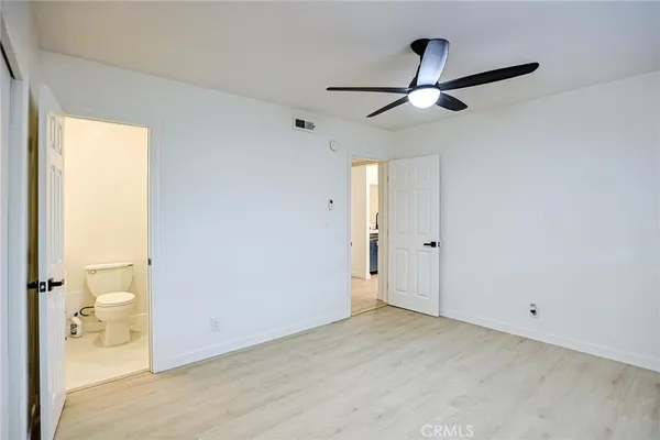 a bathroom with a sink mirror vanity and toilet