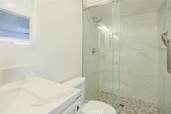 a bathroom with a shower and a glass door
