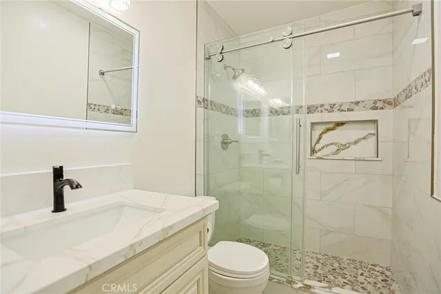 a bathroom with a shower a toilet and sink