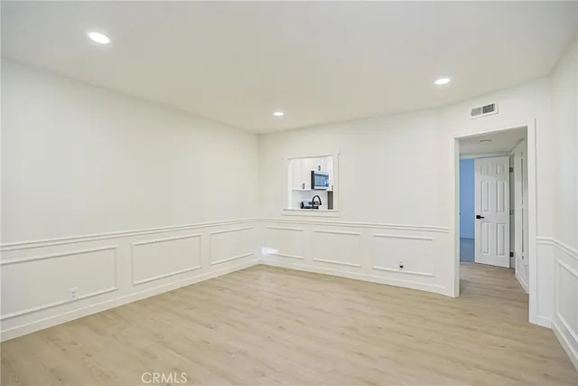 an empty room with cabinet and mirrors