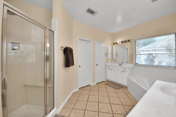 a bathroom with a shower and a bathtub