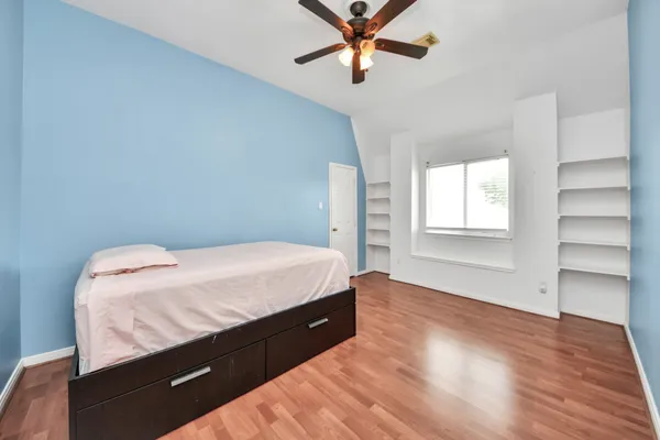 a bedroom with a bed and a window