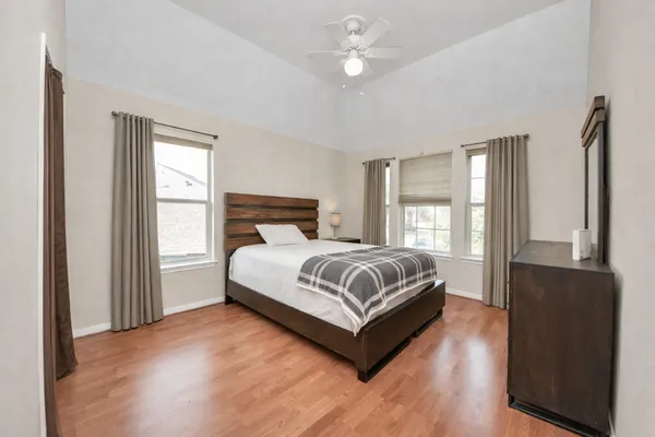 a bedroom with a bed and wooden floor