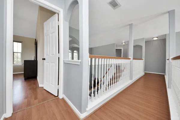 a view of a hallway with a wooden floor