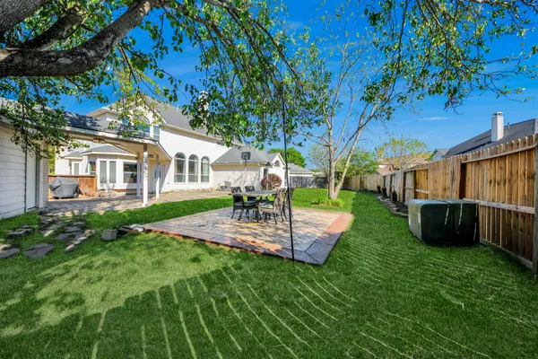a view of a house with backyard sitting area and garden