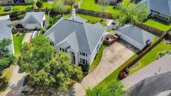 an aerial view of a house with a yard and outdoor seating