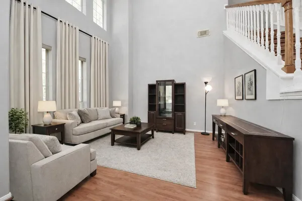 a living room with furniture and wooden floor