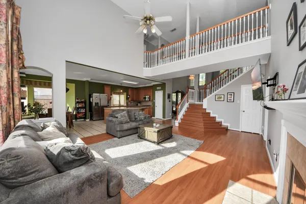 a living room with furniture and a chandelier