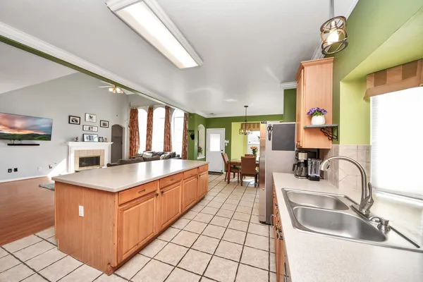 a kitchen with stainless steel appliances granite countertop a sink and a refrigerator