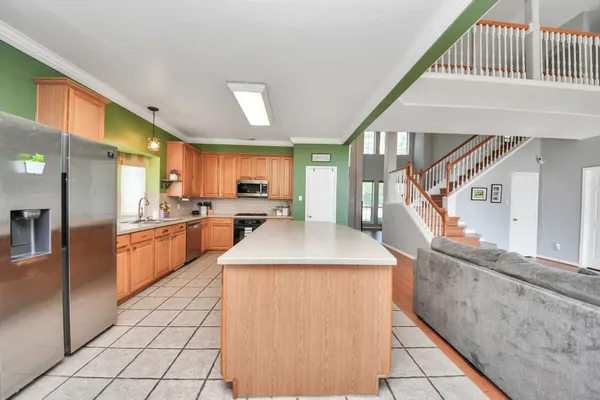 a kitchen with stainless steel appliances granite countertop a sink and a stove