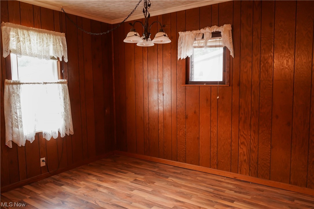 326 Pangborn Road Leavittsburg, OH 44430 - Photo 8 of 25 Spare room featuring wood walls and dark hardwood floors