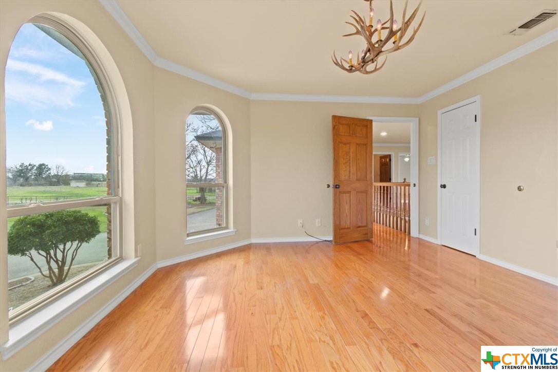 6503 Wells Fargo Road Killeen, TX 76542 - Photo 28 of 48 a view of empty room with wooden floor and a window