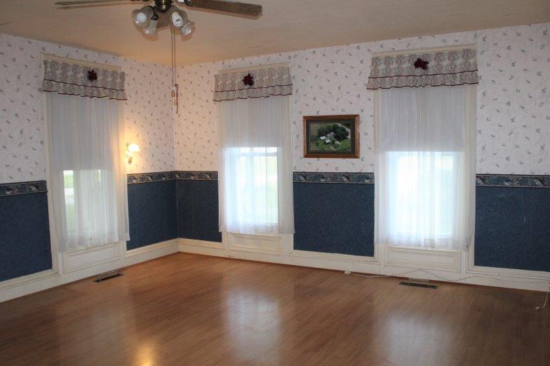 11700 Lincoln Road Morrison, IL 61270 - Photo 11 of 45 an empty room with wooden floor cabinet and windows