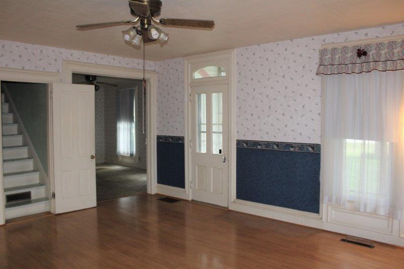 11700 Lincoln Road Morrison, IL 61270 - Photo 12 of 45 an empty room with wooden floor fireplace and windows