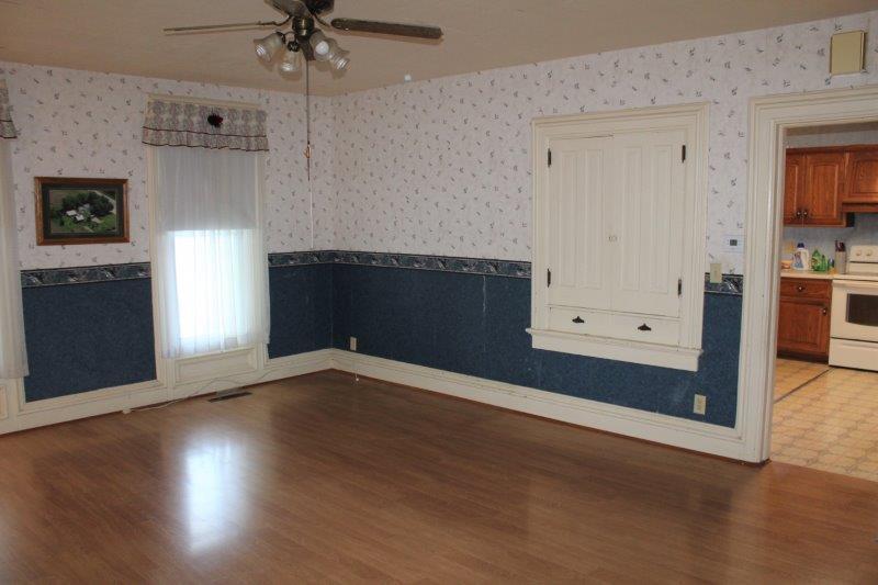 11700 Lincoln Road Morrison, IL 61270 - Photo 13 of 45 an empty room with wooden floor a ceiling fan and windows