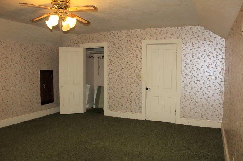 11700 Lincoln Road Morrison, IL 61270 - Photo 27 of 45 an empty room with a chandelier fan and wooden floor