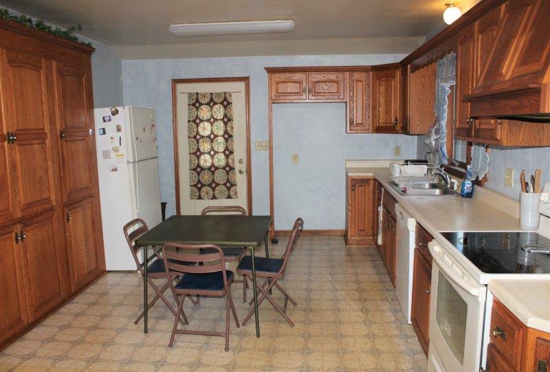 11700 Lincoln Road Morrison, IL 61270 - Photo 7 of 45 a kitchen with a cabinets and chairs