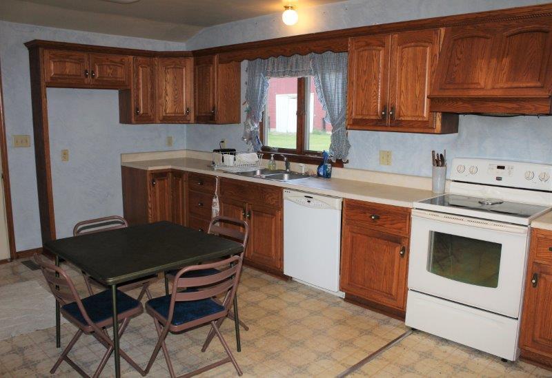 11700 Lincoln Road Morrison, IL 61270 - Photo 8 of 45 a kitchen with a stove a sink a table and chairs