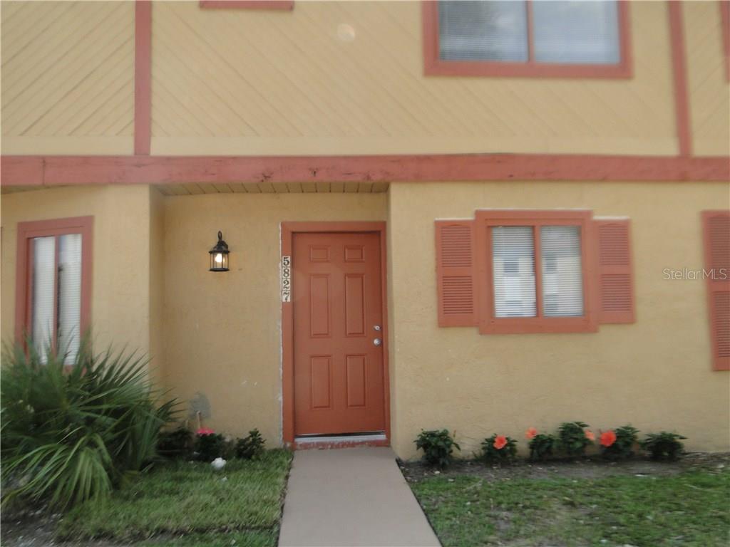 5827 Curry Ford Road, Unit 200 Orlando, FL 32822 - Photo 1 of 1 a front view of a house with garden