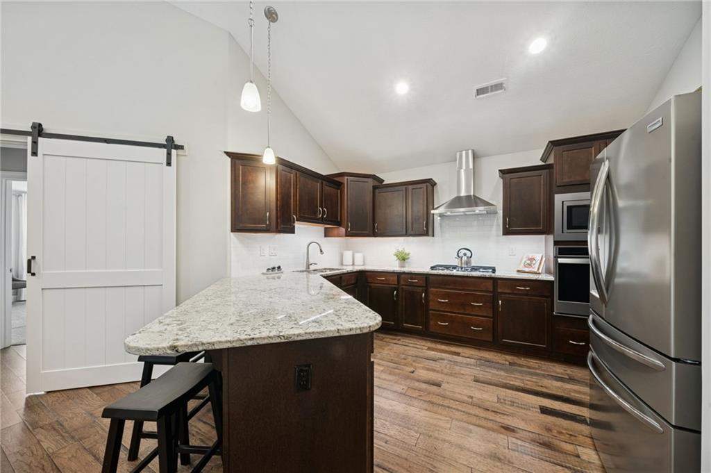 336 Saddlebrook Road Gibsonia, PA 15044 - Photo 13 of 35 a kitchen with granite countertop a refrigerator and a stove top oven