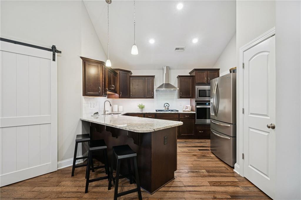336 Saddlebrook Road Gibsonia, PA 15044 - Photo 14 of 35 a kitchen with stainless steel appliances a sink stove refrigerator and wooden floor