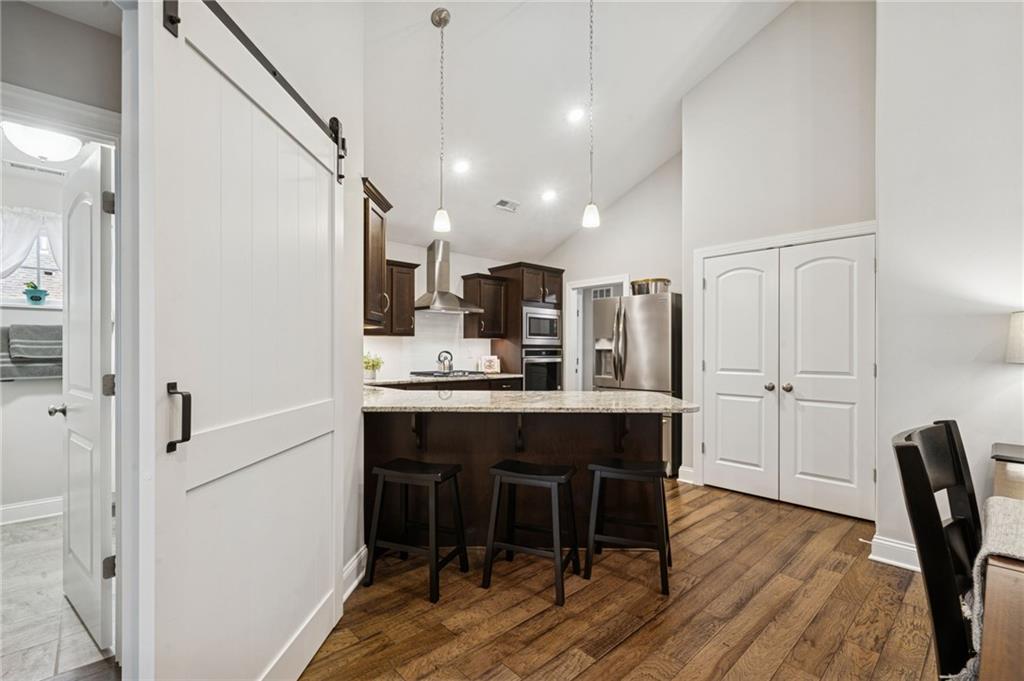 336 Saddlebrook Road Gibsonia, PA 15044 - Photo 19 of 35 a kitchen with kitchen island a dining table chairs stainless steel appliances and cabinets