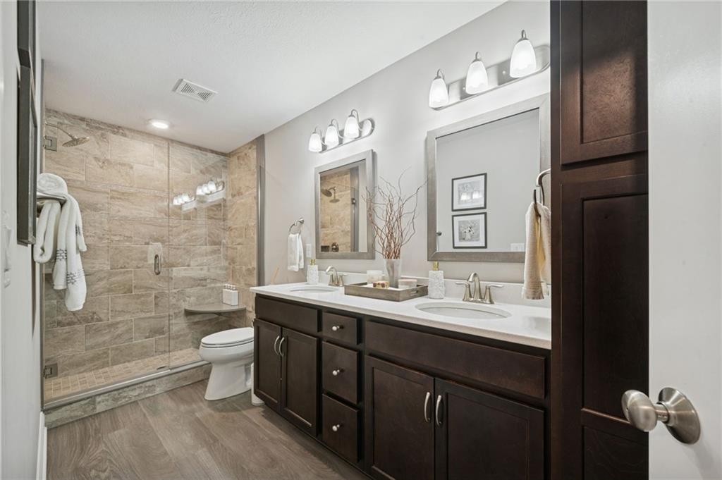 336 Saddlebrook Road Gibsonia, PA 15044 - Photo 25 of 35 a bathroom with a double vanity sink toilet mirror and shower