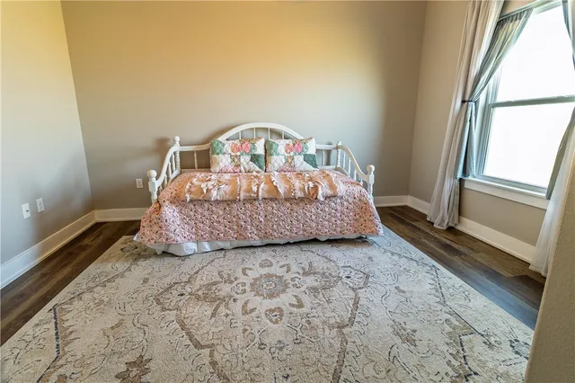 a bedroom with a bed next to a window