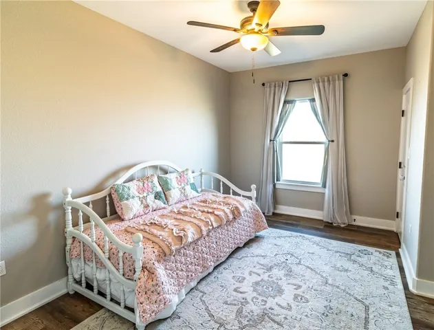 a bedroom with a bed next to a window