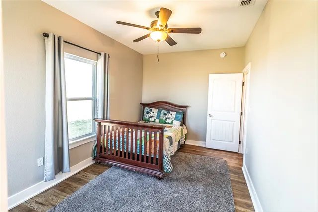 a view of a bedroom with a bed and a chandelier
