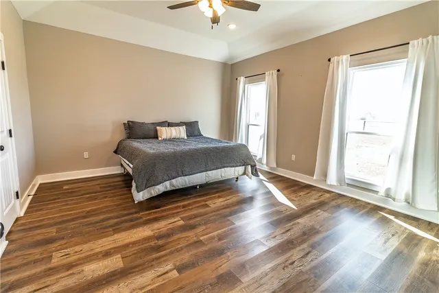 a spacious bedroom with a bed and a chandelier