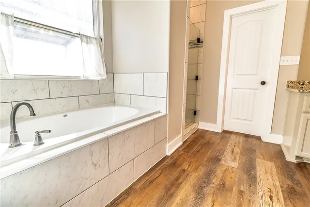 a bathroom with a bathtub and shower