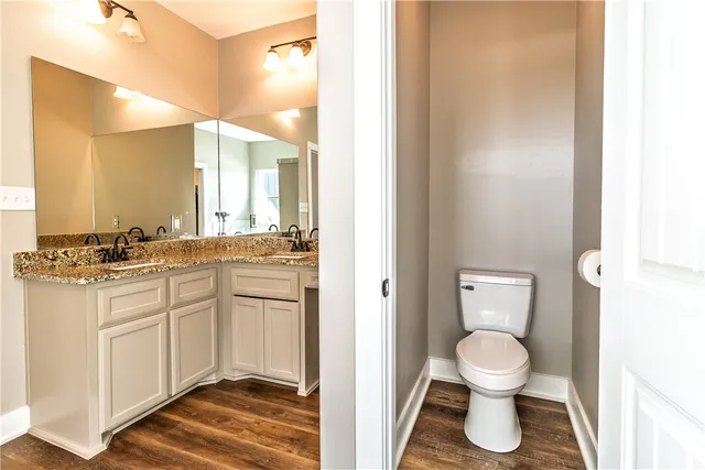 a bathroom with a sink toilet and a mirror