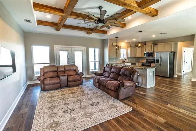 a living room with furniture and a chandelier