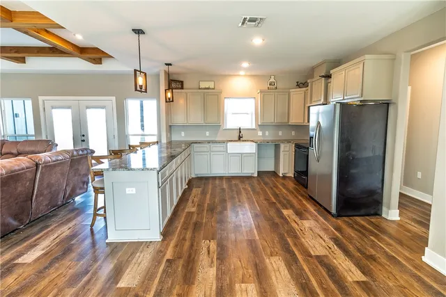 a large kitchen with a lot of counter space and stainless steel appliances