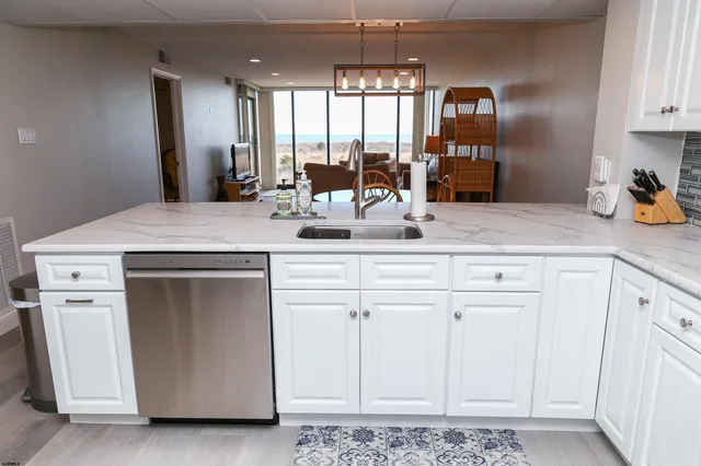 a kitchen with white cabinets and white appliances