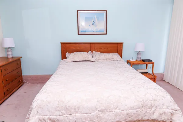 a bedroom with bed and cupboard