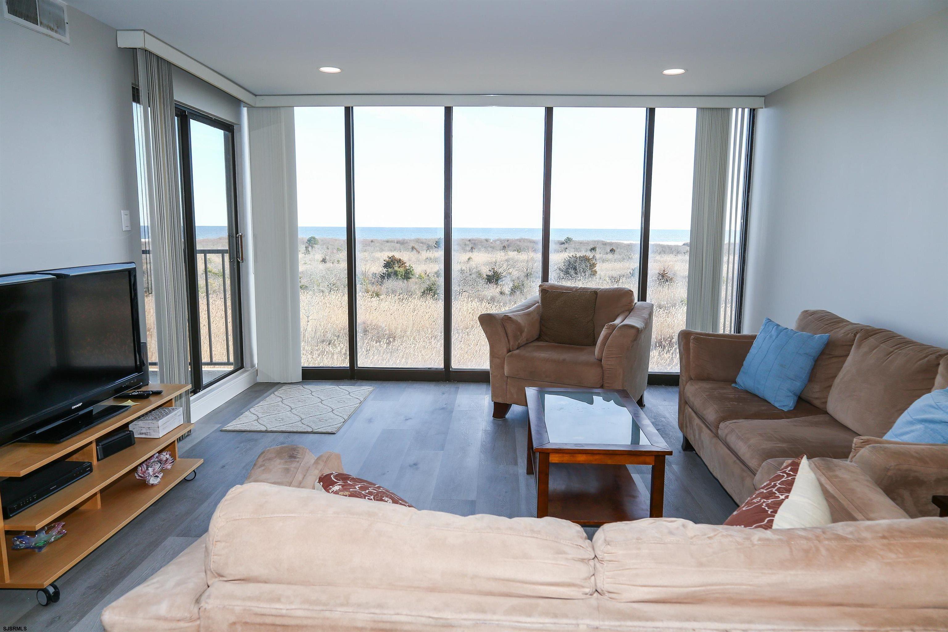 4540 West Brigantine Avenue, Unit N408 Brigantine, NJ 08203 - Photo 14 of 42 a living room with furniture and a flat screen tv