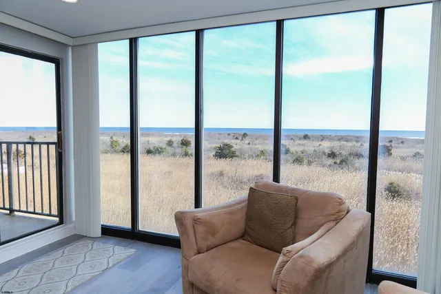 a living room with a large window and a table