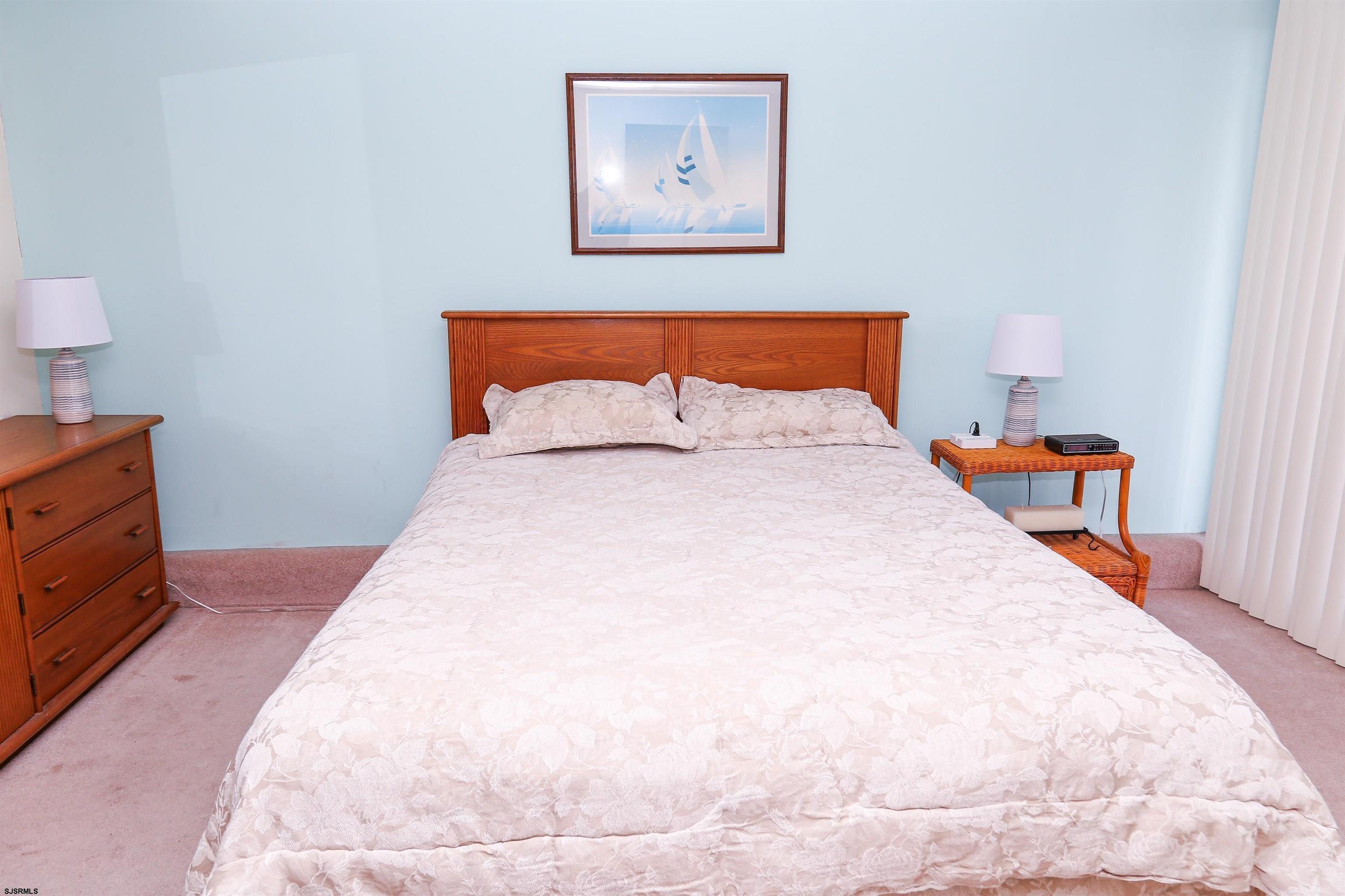 4540 West Brigantine Avenue, Unit N408 Brigantine, NJ 08203 - Photo 20 of 42 a bedroom with bed and cupboard