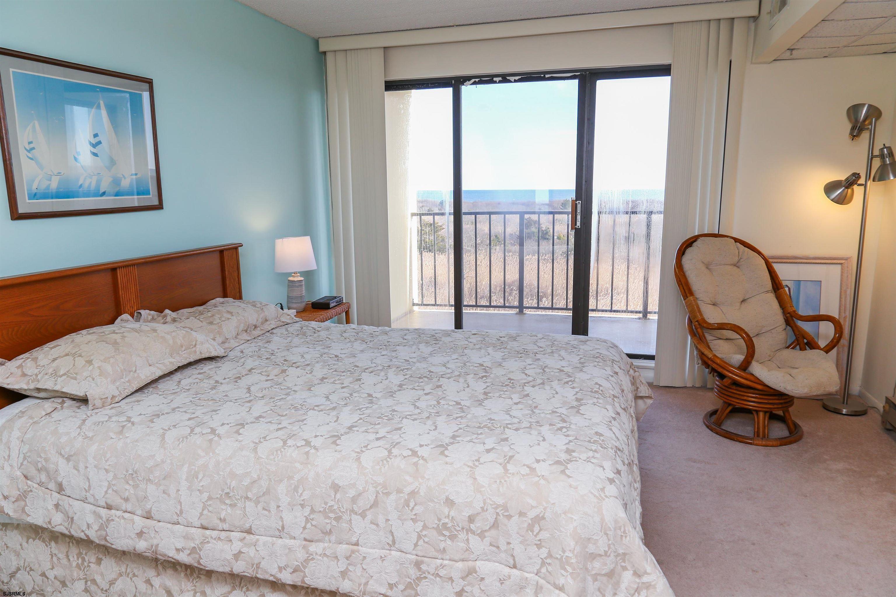 4540 West Brigantine Avenue, Unit N408 Brigantine, NJ 08203 - Photo 21 of 42 a bed sitting in a room next to a window