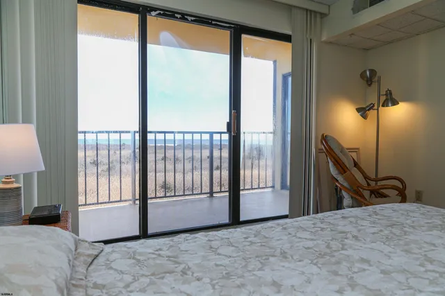 a view of a room with a large bed and chair