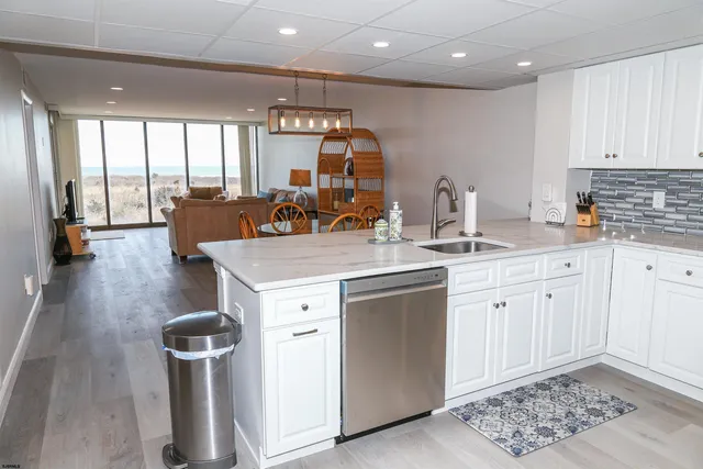 a kitchen with stainless steel appliances granite countertop a sink a stove and a refrigerator