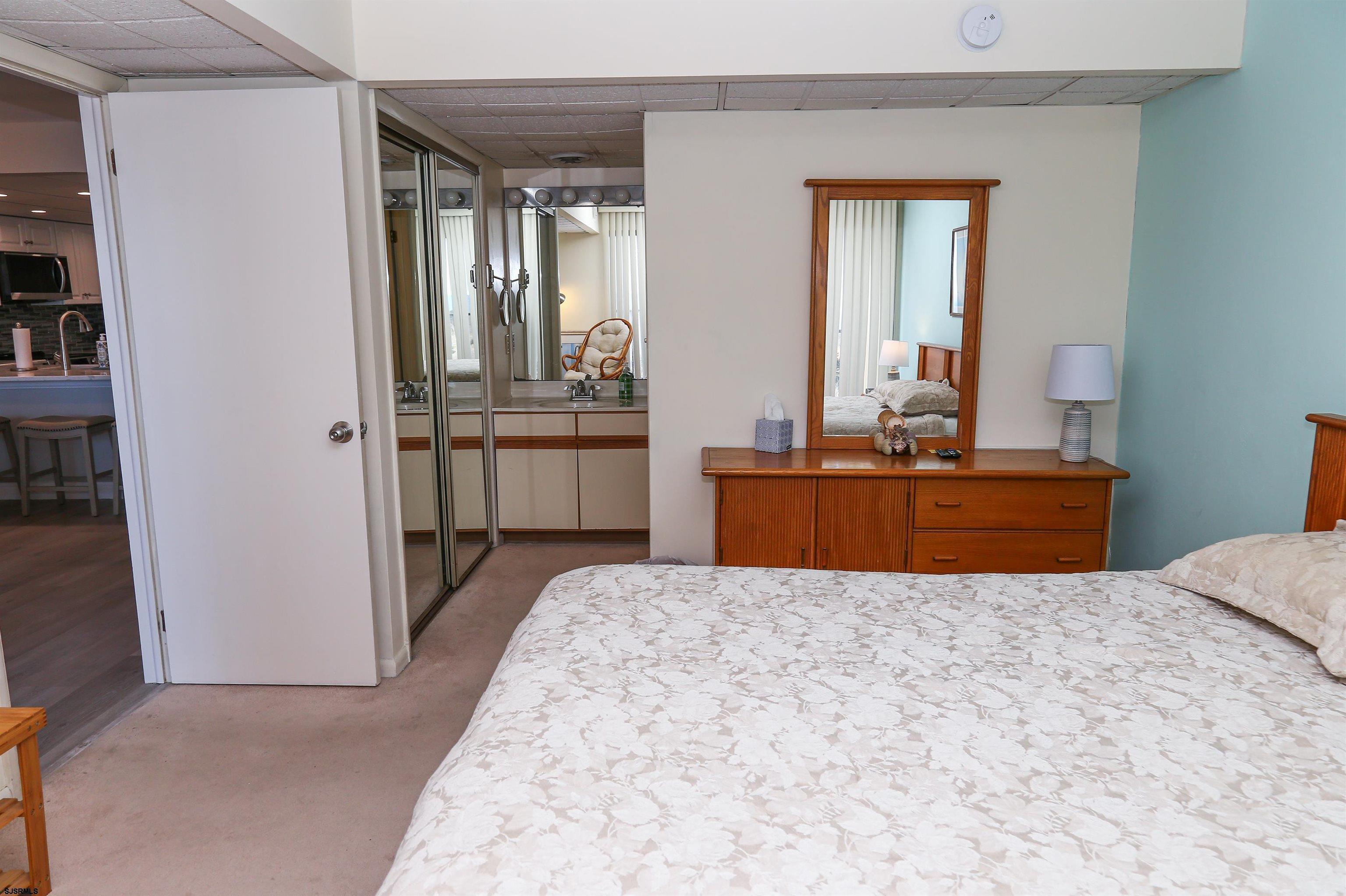 4540 West Brigantine Avenue, Unit N408 Brigantine, NJ 08203 - Photo 32 of 42 a room with a bed and a dresser in it